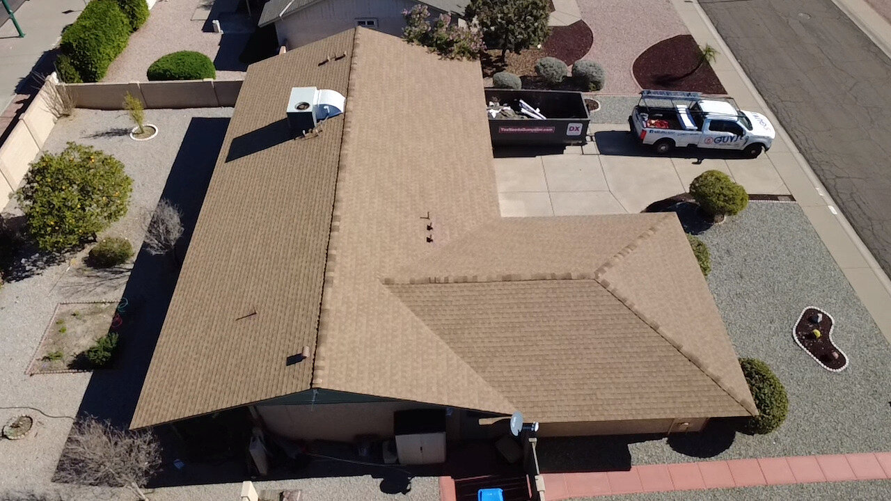 After photo showing completed shingle roof replacement in Phoenix with finished edges and sealed penetrations