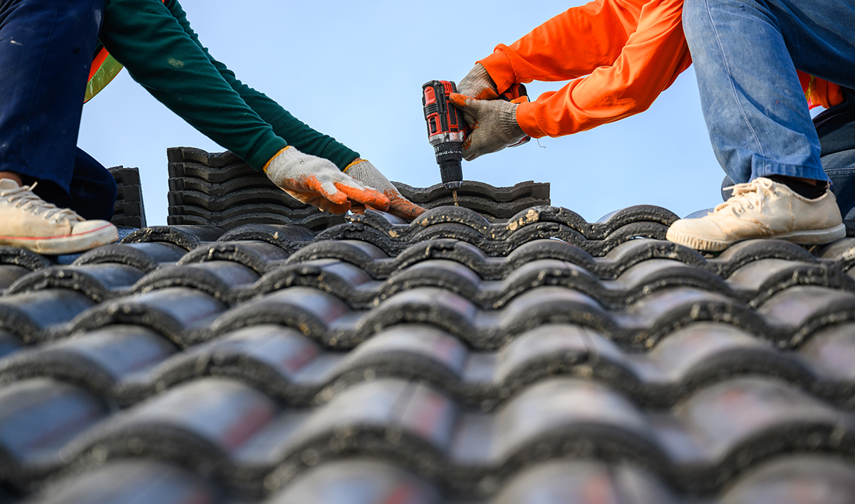 Roof Replacement FAQs: Your Comprehensive Guide 6 Close Up Photo Of A Roofer Working On The Roof Of The House Use